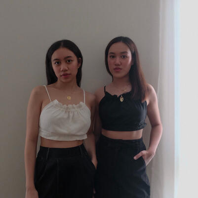 Two girls wearing white top and black top